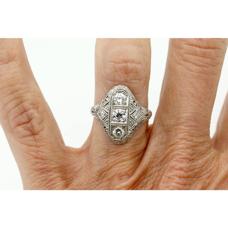 Antique Edwardian three stone diamond ring with filigree detail on hand