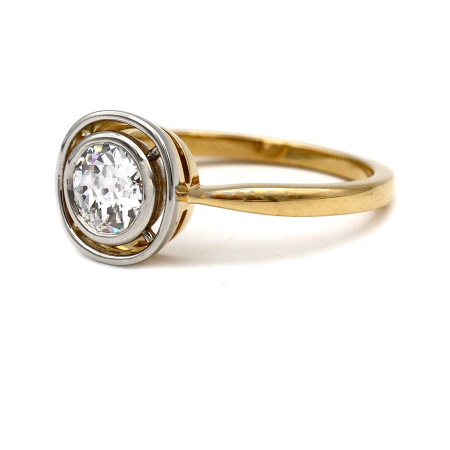 Side profile of a two-tone Victorian-style engagement ring showing the old mine cut diamond and antique metalwork