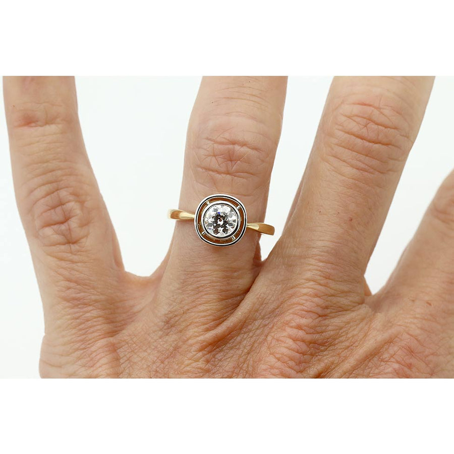 Two-tone Victorian-style old mine cut diamond engagement ring shown on a hand, highlighting the .54 carat GIA G/VS1 center stone and antique details