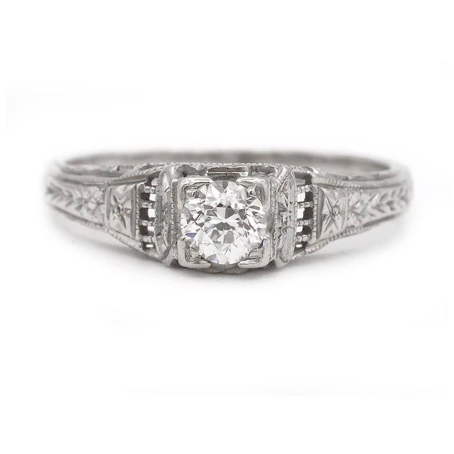 Art Deco .25 carat Old Mine cut diamond engagement ring 18K white gold star-engraved shoulders geometric frame circa 1930s