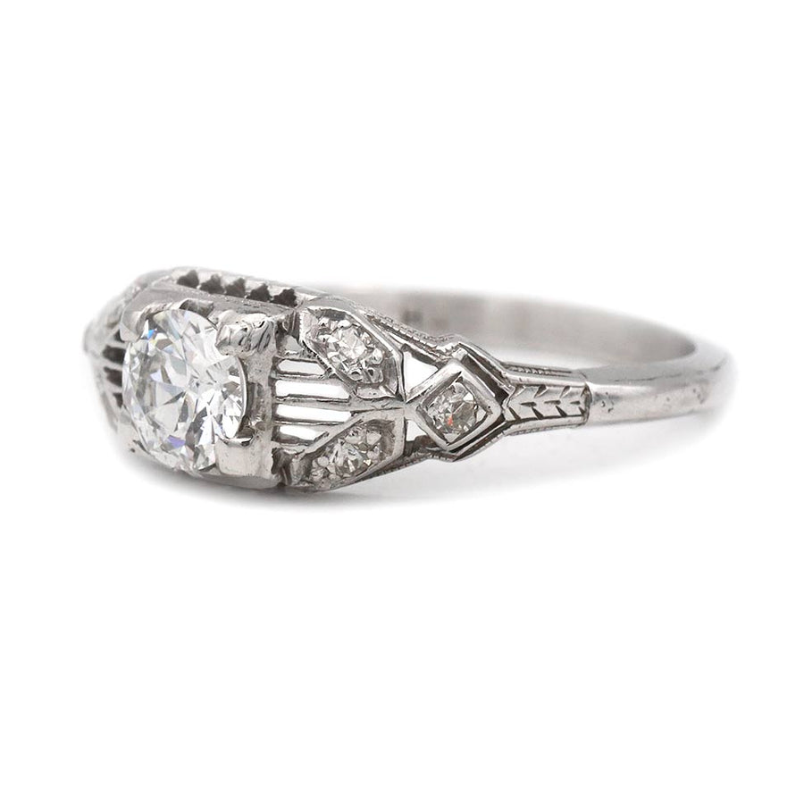 Side profile of Art Deco 18K white gold engagement ring showing open metalwork shank and milgrain detailing circa 1930s