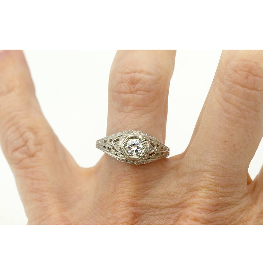 Art Deco engagement ring with .30 carat old European cut diamond H SI1 in 18K white gold geometric hexagonal frame on hand
