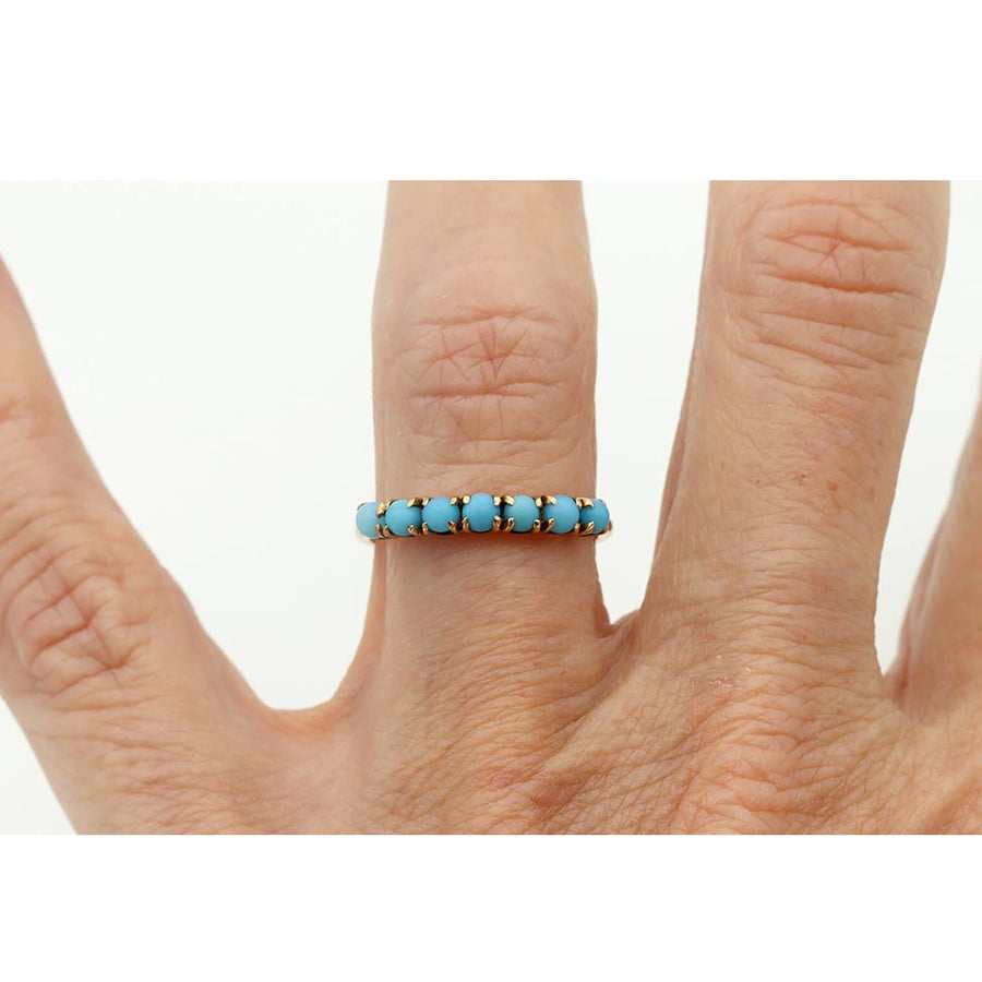 Victorian turquoise wedding band in 10 karat rose gold worn on hand
