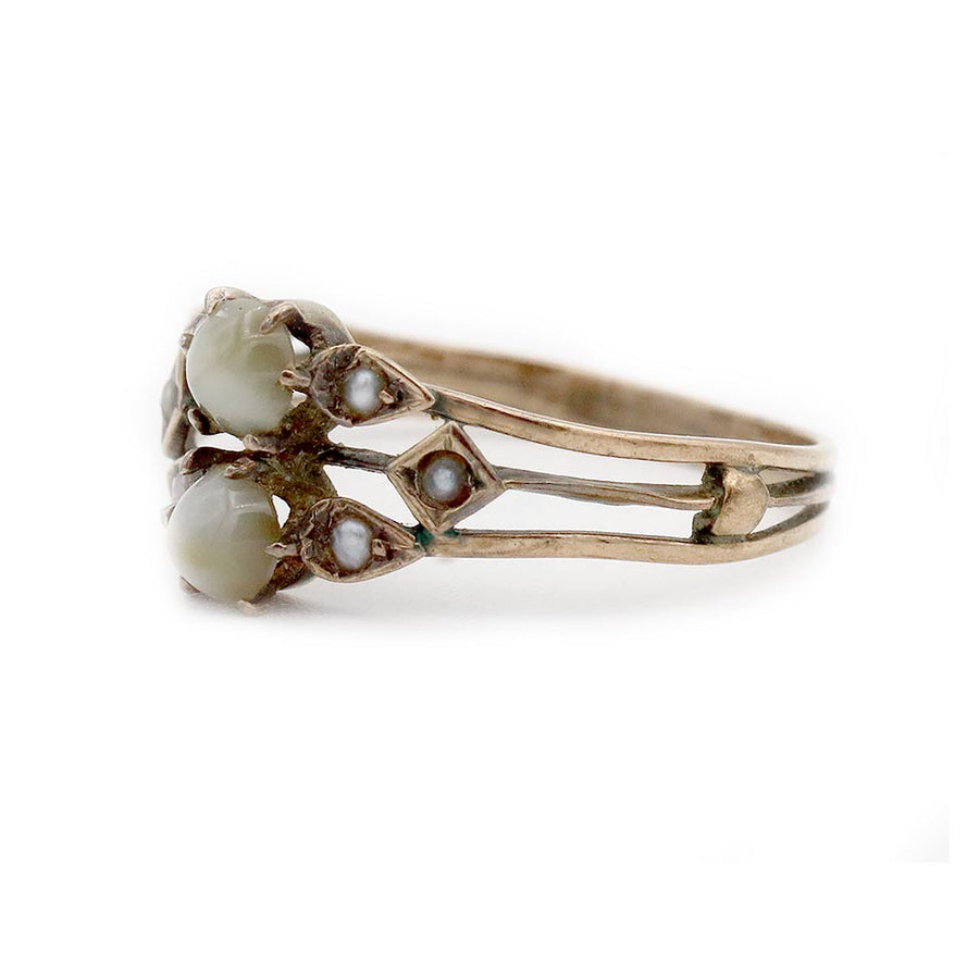 Side profile of Victorian cat’s eye chrysoberyl and seed pearl engagement ring showing 10K rose gold setting