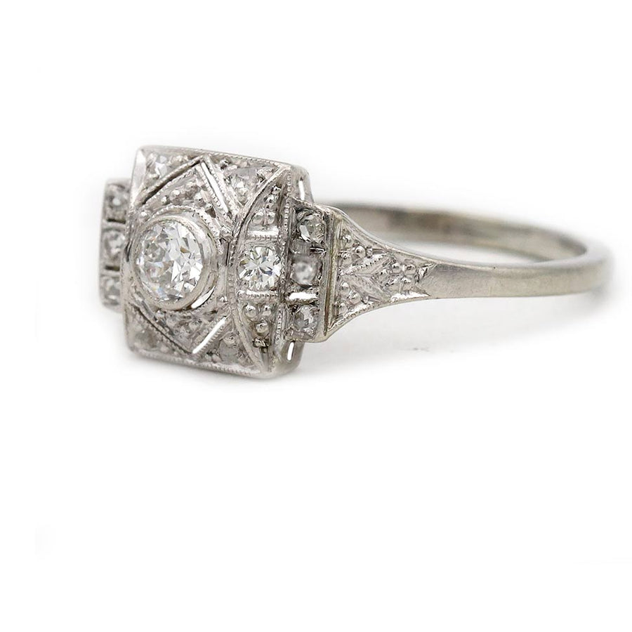 vintage art deco bezel set european cut diamond engagement ring in 18 kt white gold displayed from the side