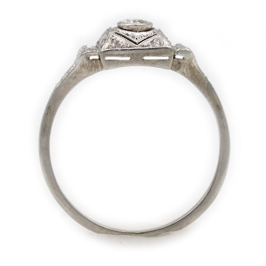 vintage art deco bezel set european cut diamond engagement ring in 18 kt white gold photographed in a gallery view showing the metalwork