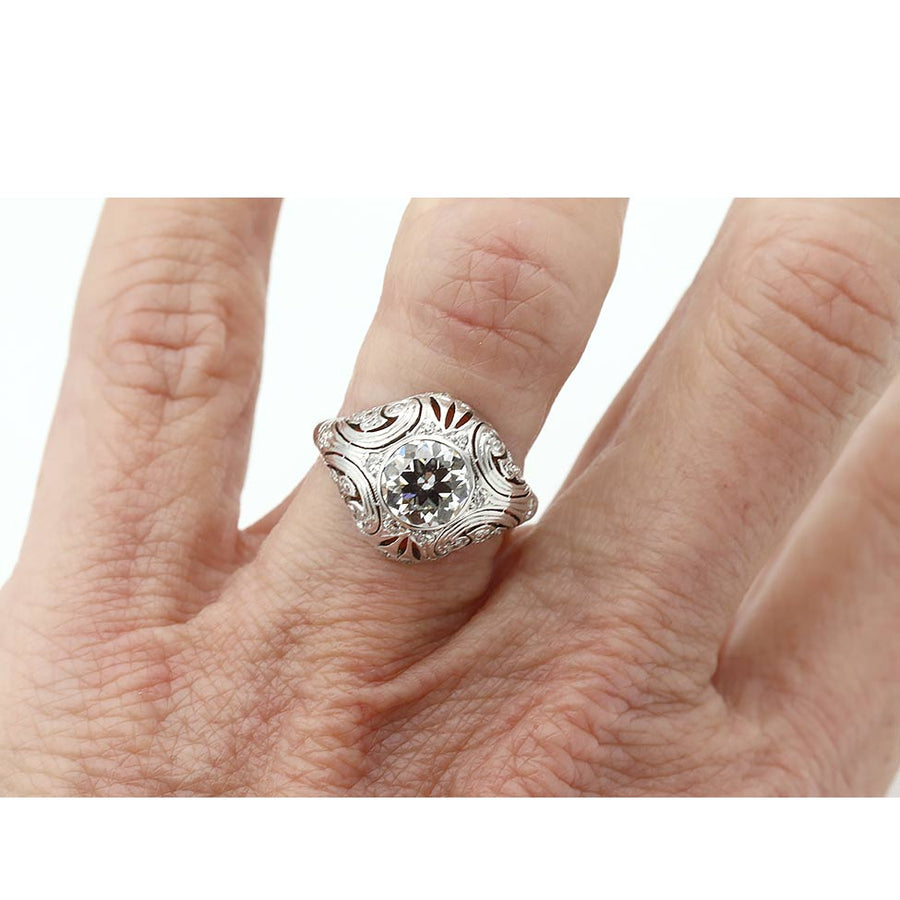 Close-up of 1.17 ct Old European cut diamond with single-cut accents and open filigree metalwork on hand