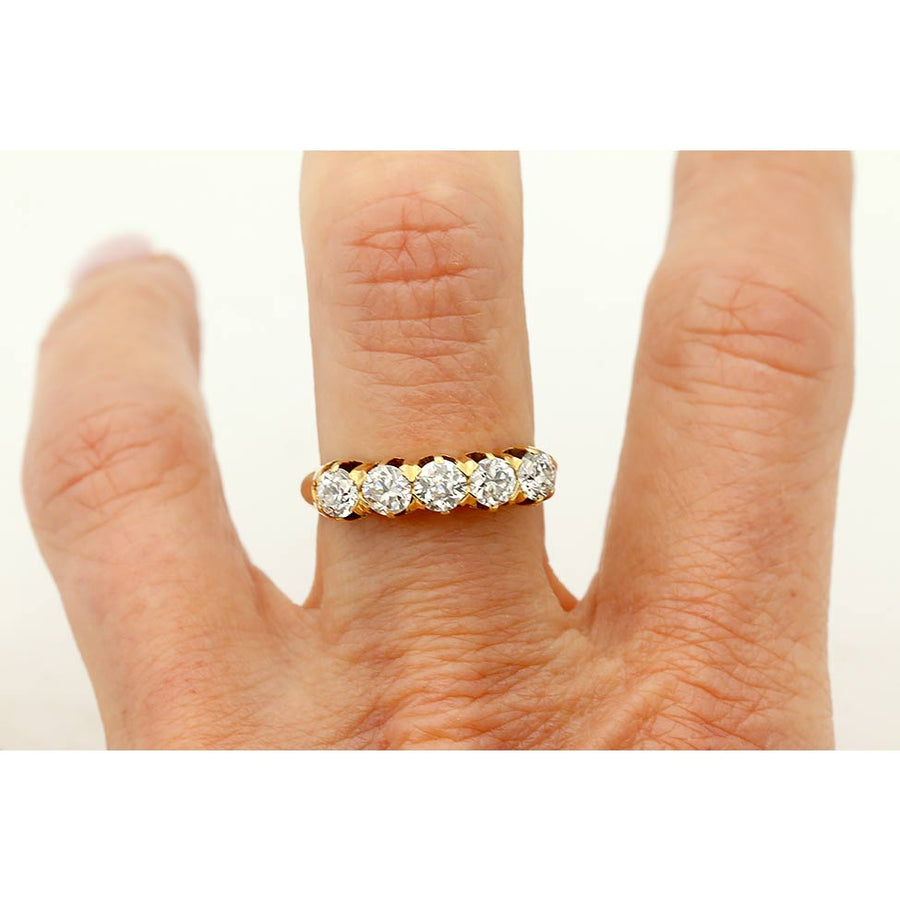 Antique Victorian diamond wedding band in rosy yellow gold on hand