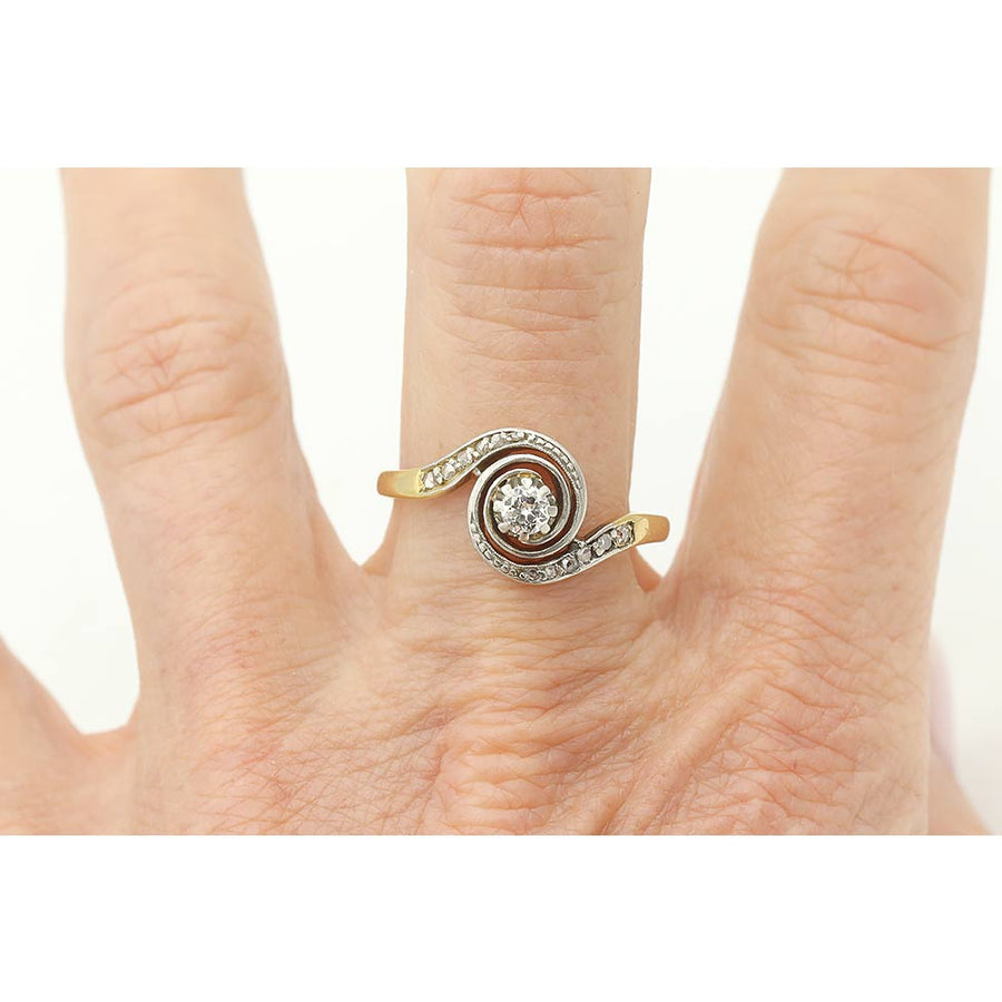 Antique Victorian bypass diamond ring in platinum and gold on hand