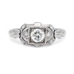 Art Deco .39 carat total weight Old European cut diamond engagement ring 18K white gold scrollwork shoulders circa 1920s