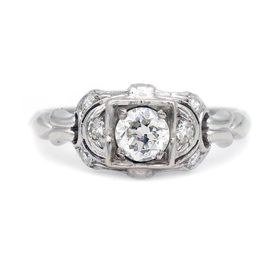 Art Deco .39 carat total weight Old European cut diamond engagement ring 18K white gold scrollwork shoulders circa 1920s