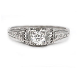 Art Deco .25 carat Old Mine cut diamond engagement ring 18K white gold star-engraved shoulders geometric frame circa 1930s