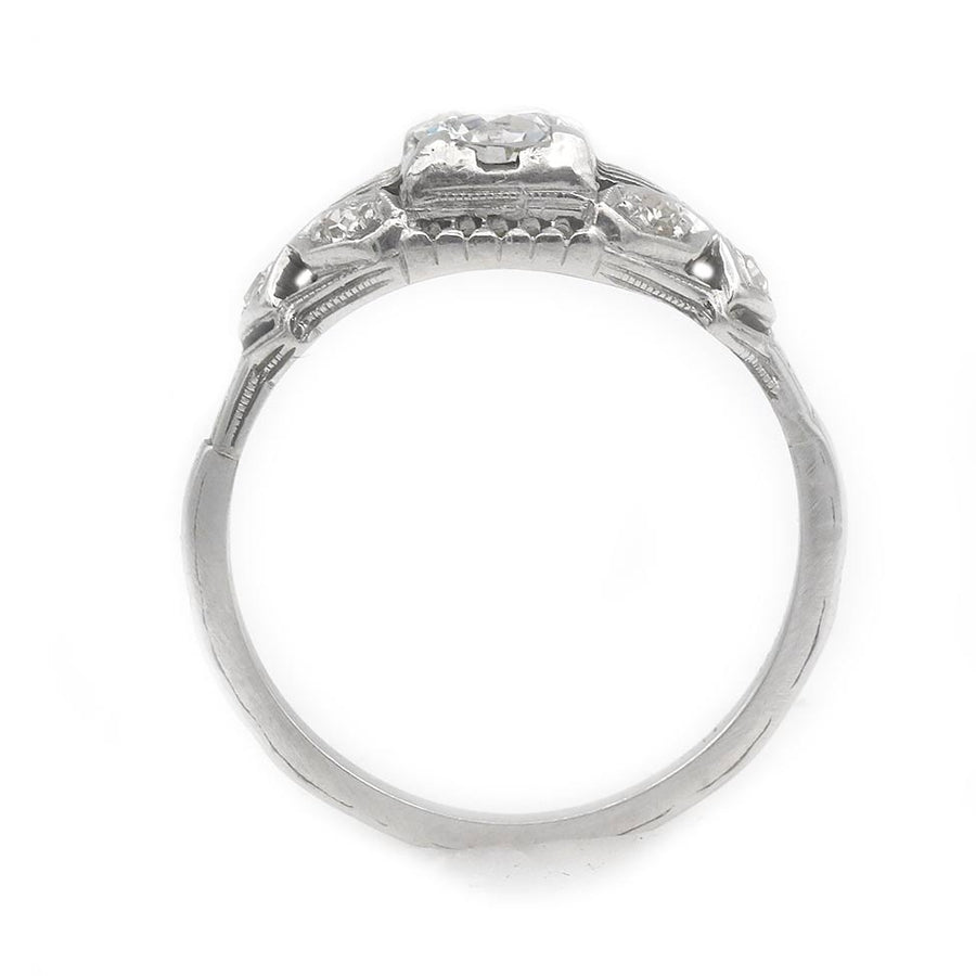 Close-up of GIA certified .53 carat old European cut diamond E color SI2 clarity in Art Deco 18K white gold geometric setting with milgrain engravings
