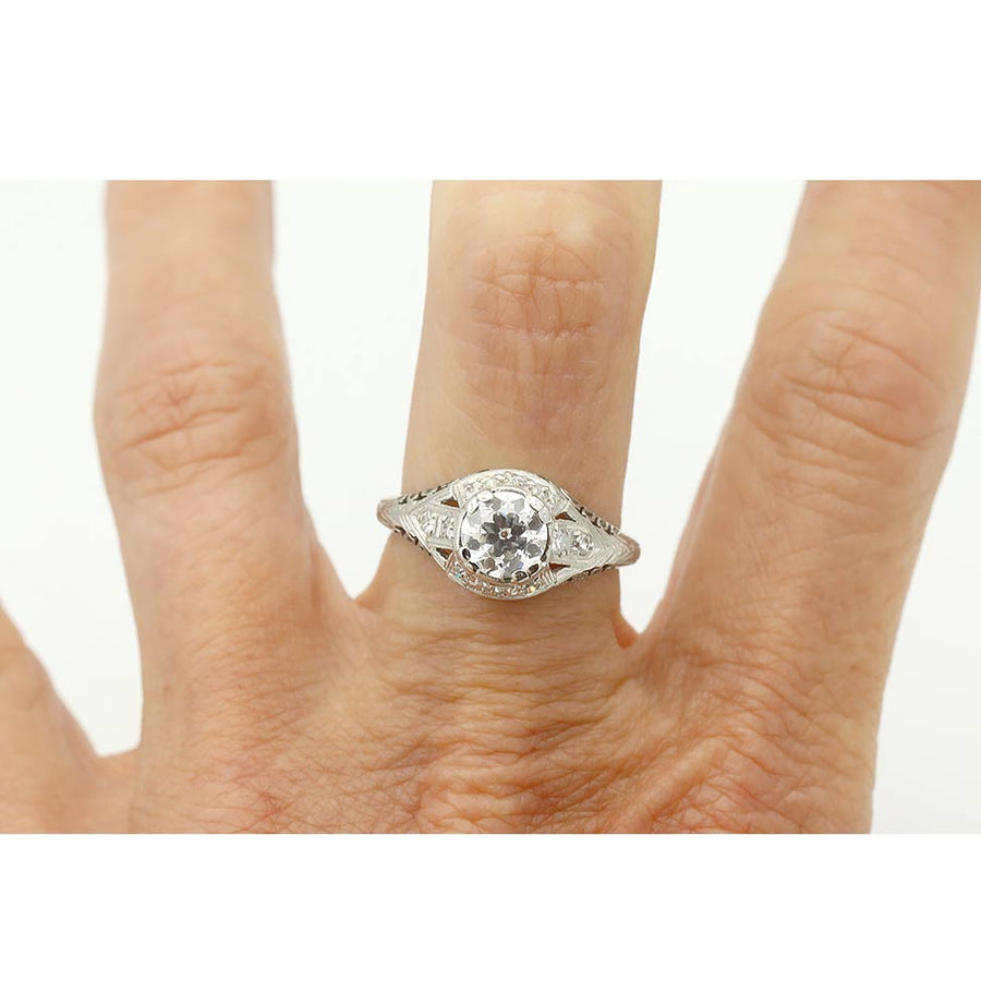 Art Deco platinum engagement ring .91 carat GIA certified old European cut diamond D I1 with milgrain engravings and open metalwork circa 1930s on hand