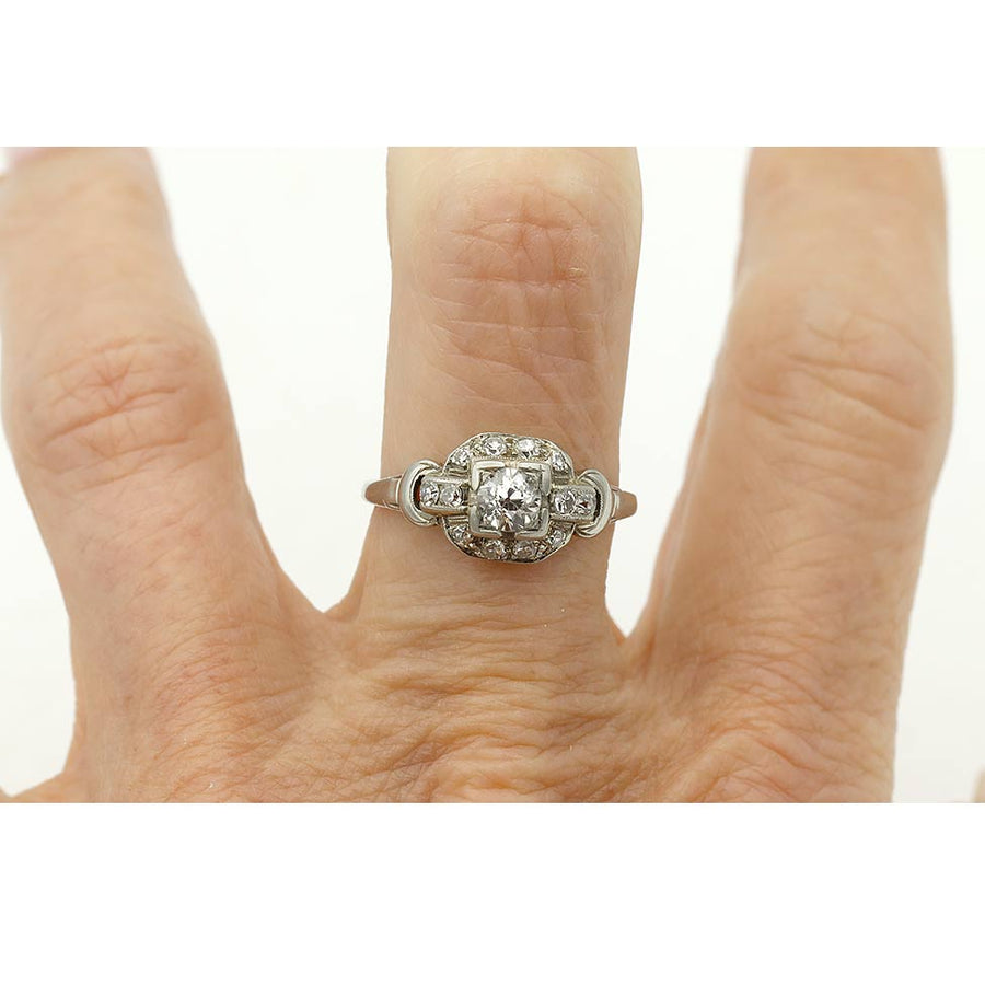 Art Deco old mine cut diamond engagement ring in 14K white gold featuring a geometric square frame on the hand.