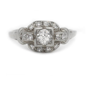 Art Deco old mine cut diamond engagement ring in 14K white gold featuring a geometric square frame, diamond accents, and milgrain detail.