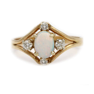 Front view of vintage opal engagement ring with 1 carat cabochon opal and transitional cut diamonds in 14K yellow gold