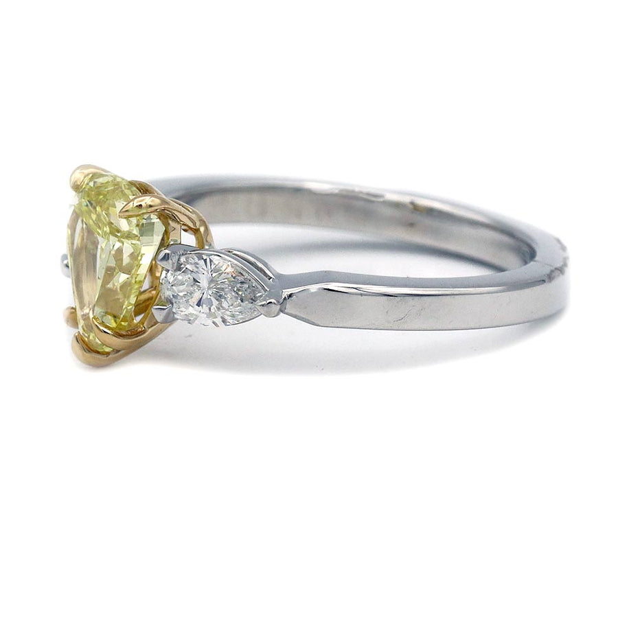 Side profile of vintage style yellow diamond three stone engagement ring with knife edge prong setting