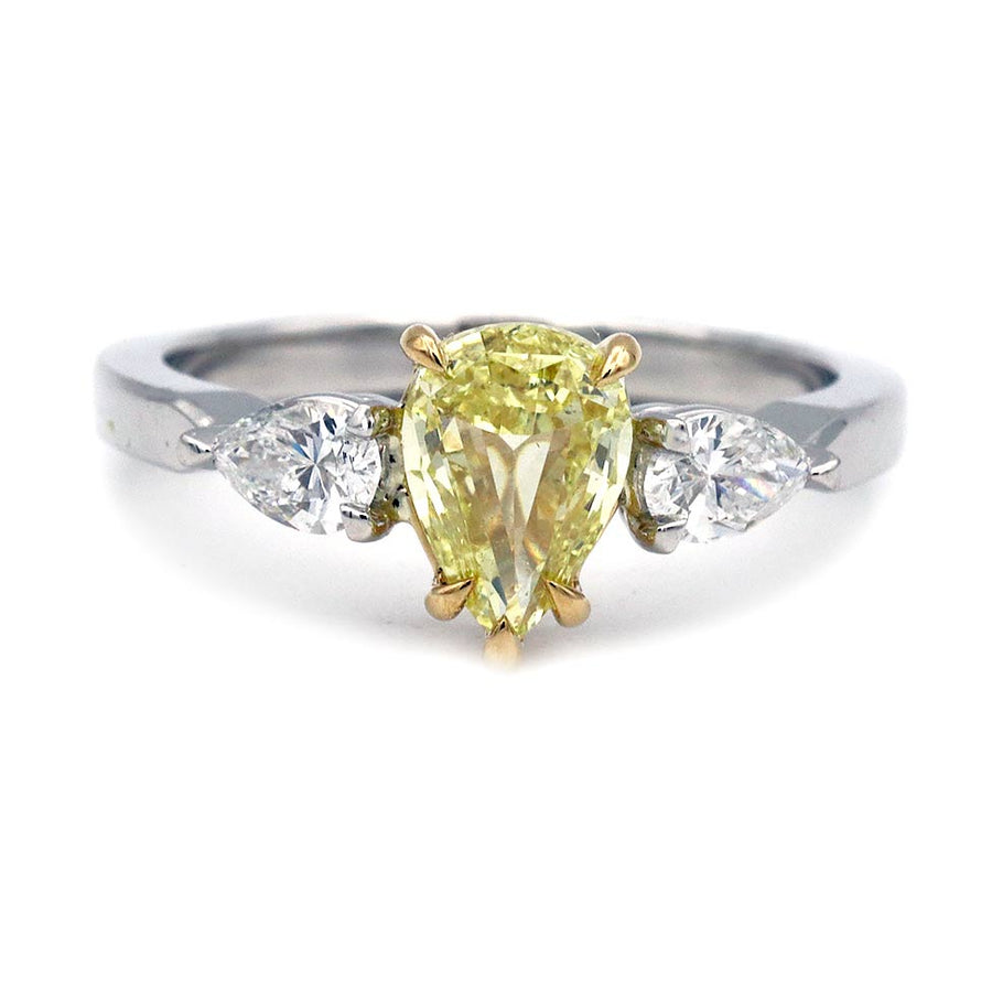Fancy intense yellow diamond engagement ring with GIA 1.02 ct pear shape center and three stone design in platinum and 18K yellow gold, front view