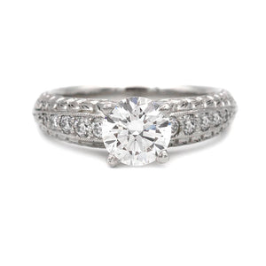 Vintage Scott Kay platinum engagement ring featuring an IGI certified 1.28 carat lab grown round brilliant diamond with natural pave diamond accents and filigree detail.