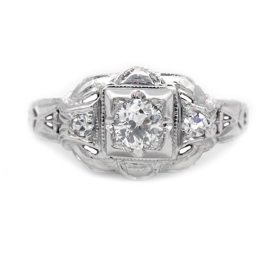 Art Deco three stone engagement ring in 14K white gold featuring an old European cut diamond in a geometric square frame with diamond side stones.