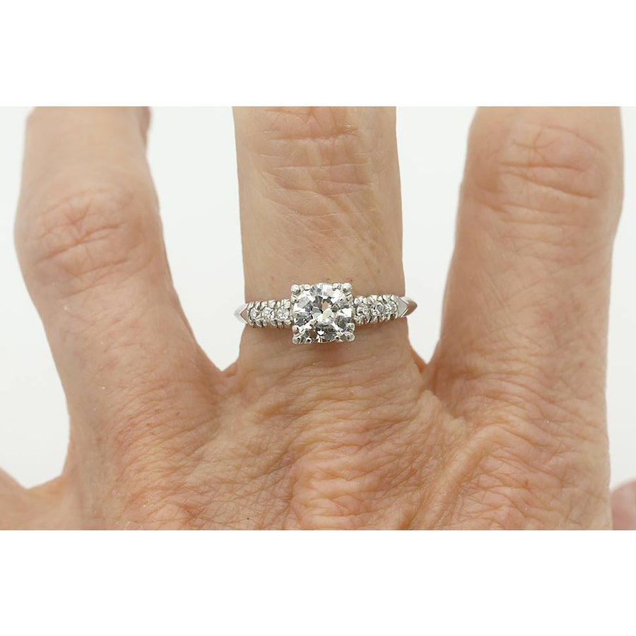 Mid-Century platinum engagement ring featuring a .75 carat transitional cut diamond in trefoil prongs with transitional cut diamond accents on hand.