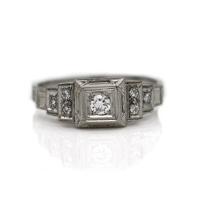 Intricate Diamond Engagement Ring with Tiered Side Diamonds